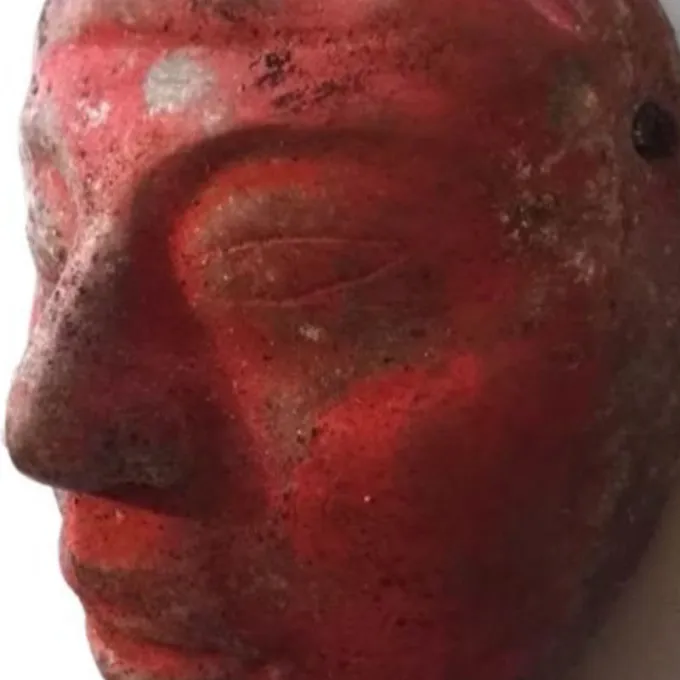 Jade mask from Burial 80, painted red with cinnabar paint